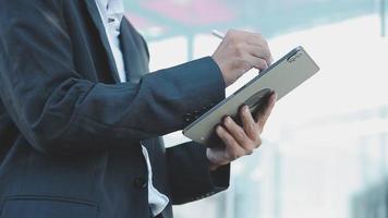 Businessman using tablet analyzing sales data and economic growth graph chart. Business strategy. Abstract icon. Digital marketing. video