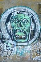 Fragment of graffiti drawings. The old wall decorated with paint stains in the style of street art culture. Scary scuba diver photo