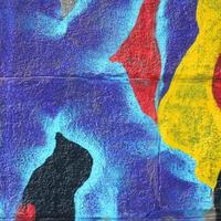 Fragment of graffiti drawings. The old wall decorated with paint stains in the style of street art culture. Multicolored background texture photo