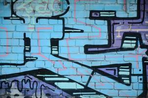 Fragment of graffiti drawings. The old wall decorated with paint stains in the style of street art culture. Colored background texture in cold tones photo
