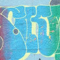 Fragment of graffiti drawings. The old wall decorated with paint stains in the style of street art culture. Colored background texture in cold tones photo