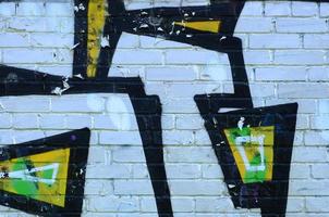 Fragment of graffiti drawings. The old wall decorated with paint stains in the style of street art culture. Colored background texture photo