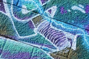 Fragment of graffiti drawings. The old wall decorated with paint stains in the style of street art culture. Colored background texture in cold tones photo