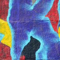 Fragment of graffiti drawings. The old wall decorated with paint stains in the style of street art culture. Multicolored background texture photo