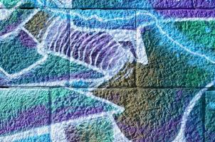 Fragment of graffiti drawings. The old wall decorated with paint stains in the style of street art culture. Colored background texture in cold tones photo