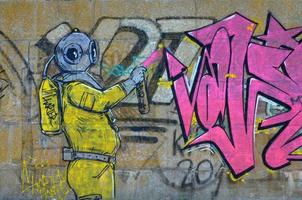 Fragment of graffiti drawings. The old wall decorated with paint stains in the style of street art culture. Scary scuba diver photo