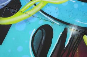 Fragment of graffiti drawings. The old wall decorated with paint stains in the style of street art culture. Colored background texture in cold tones photo