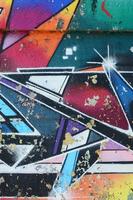 Fragment of graffiti drawings. The old wall decorated with paint stains in the style of street art culture. Multicolored background texture photo
