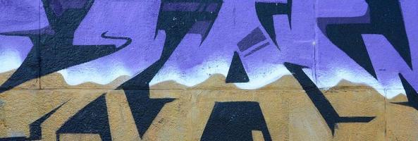 Fragment of graffiti drawings. The old wall decorated with paint stains in the style of street art culture. Colored background texture in purple tones photo