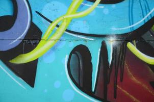 Fragment of graffiti drawings. The old wall decorated with paint stains in the style of street art culture. Colored background texture in cold tones photo