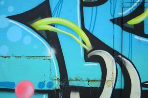 Fragment of graffiti drawings. The old wall decorated with paint stains in the style of street art culture. Colored background texture in cold tones photo