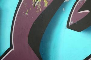 Fragment of graffiti drawings. The old wall decorated with paint stains in the style of street art culture. Colored background texture in cold tones photo