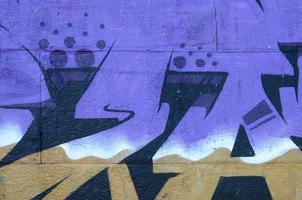 Fragment of graffiti drawings. The old wall decorated with paint stains in the style of street art culture. Colored background texture in purple tones photo