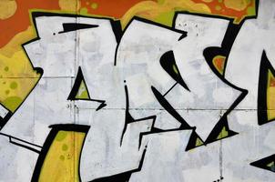 Street art. Colorful graffiti on the wall. Fragment for background. Abstract detail of a graffiti photo