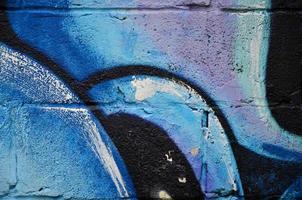 Background image of the wall decorated with colorful abstract graffiti. Street art concept photo