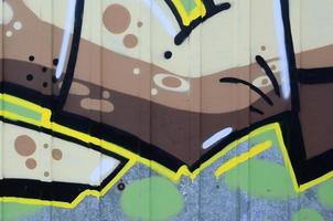 Fragment of graffiti drawings. The old wall decorated with paint stains in the style of street art culture. Colored background texture photo