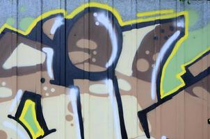 Fragment of graffiti drawings. The old wall decorated with paint stains in the style of street art culture. Colored background texture photo