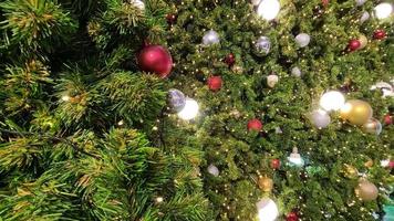 Christmas tree ornaments with twinkling lights on holiday background video