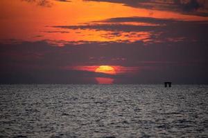 Beautiful omega sunrise and clouds in the sea photo