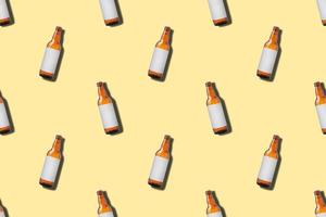 Beer bottle seamless pattern on yellow background photo
