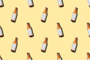 Beer bottle seamless pattern on yellow background photo