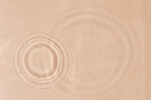 Beige water texture background. Abstract pattern photo