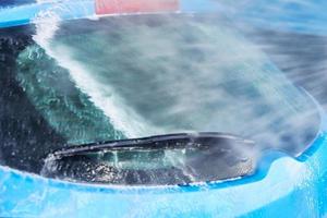 Cleaning car with high pressure water at car wash station photo