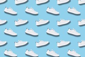 White sneakers seamless pattern on blue background photo