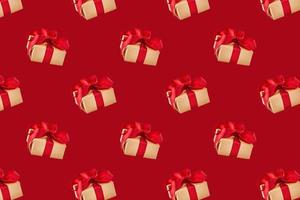 Gift box seamless pattern on red background photo