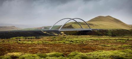 Modern bridge on scenic ring road in Iceland in the middle of lava fields photo