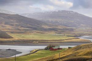 Typical farm landscape in rural Iceland during spring time covered with mist . photo