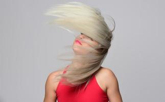 Happy satisfied woman with flying hair photo