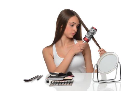 hermosa mujer joven mirarse en el cepillo de espejo cabello moreno largo y saludable foto