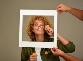 woman in picture frame blowing bubbles photo