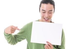 Handsome Asian man holding blank empty banner doing ok sign with fingers, smiling friendly photo