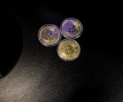 Three Gold Bitcoin Cryptocurrency Coins. photo