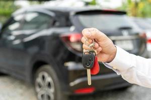 lease, rental car, sell, buy. Dealership manager send car keys to the new owner.  Sales, loan credit financial, rent vehicle, insurance,  renting, Seller, dealer, installment, car care business photo