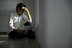 Depression and mental illness. Asian man disappoint, sad after receive bad news. Stressed boy confused with unhappy problem, arguing with girlfriend, cry and worry about unexpected work, down economy. photo