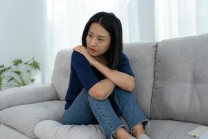 Depression and mental illness. Asian woman disappointed and sad after receiving bad news. Stressed girl confused with unhappy problems in life, arguing with her boyfriend. photo