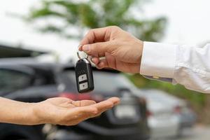 lease, rental car, sell, buy. Dealership manager send car keys to the new owner.  Sales, loan credit financial, rent vehicle, insurance,  renting, Seller, dealer, installment, car care business photo