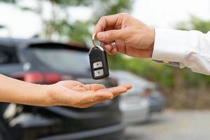 lease, rental car, sell, buy. Dealership manager send car keys to the new owner.  Sales, loan credit financial, rent vehicle, insurance,  renting, Seller, dealer, installment, car care business photo