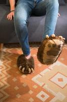 Unrecognizable young person wearing bear claw slippers photo