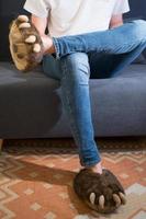 Unrecognizable young person with jeans and bear claws slippers photo