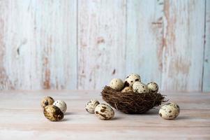 Fresh quail eggs. Rustic style on wood background. Easter banner with place for text photo
