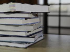 Stack or plie of vintage old books on wooden table. Learning, education and study concept. one of them open with copy space. photo