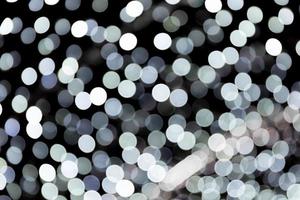 Abstract bokeh of white city lights on black background. defocused and blurred many round light photo