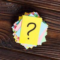 colorful question marks written reminders tickets on wooden background photo