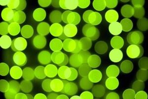 Unfocused abstract colourful bokeh black background. defocused and blurred many round green light photo