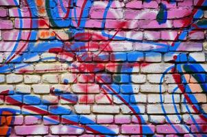 Background image with graffiti elements. Texture of the wall, painted in different colors of in the graffiti style. Concept of street culture, youth entertainment and illegal hooliganism photo