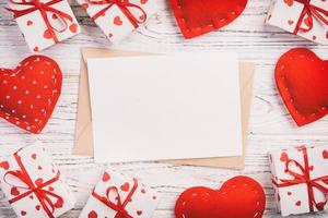 Envelope Mail with Red Heart and gift box over White Wooden Background. Valentine Day Card, Love or Wedding Greeting Concept photo